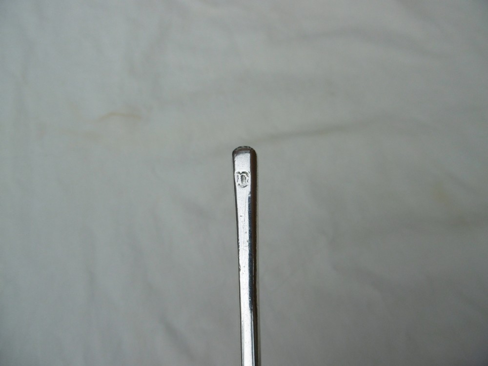 A 17th-century sterling silver slip top spoon displaying a wide fig-shaped bowl and a tapered hexagonal stem. View IV
