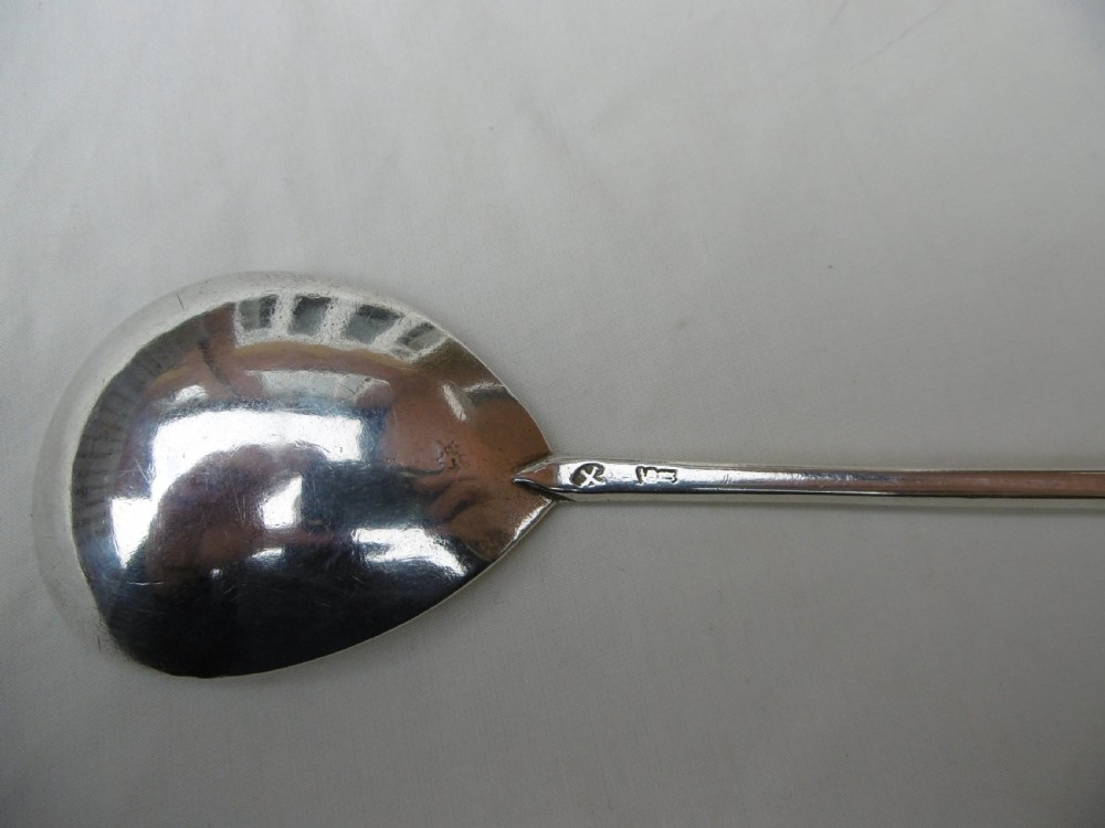 A 17th-century sterling silver slip top spoon displaying a wide fig-shaped bowl and a tapered hexagonal stem. View V