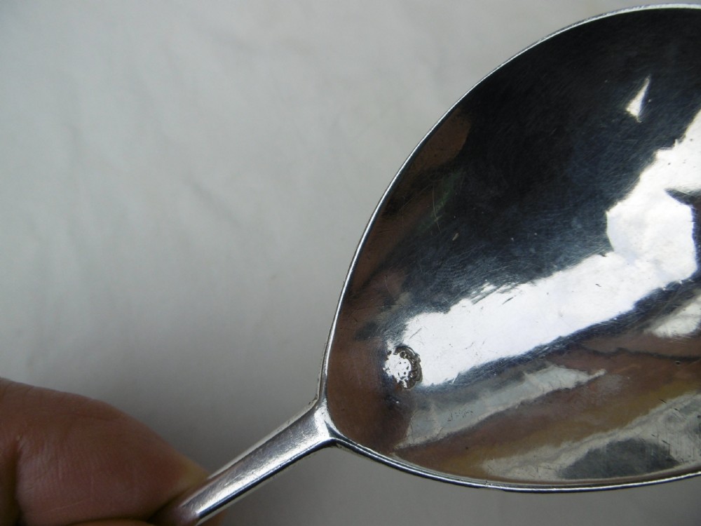 A 17th-century sterling silver slip top spoon displaying a wide fig-shaped bowl and a tapered hexagonal stem. View VI