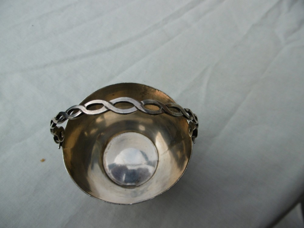 A Georgian sterling silver cream pail featuring a tapered bucket shape decorated with horizontal reeded lines and an overhead swing handle. View III