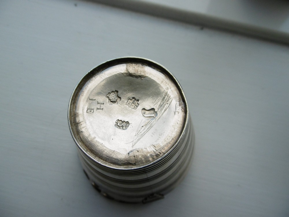 A Georgian sterling silver cream pail featuring a tapered bucket shape decorated with horizontal reeded lines and an overhead swing handle. View IV