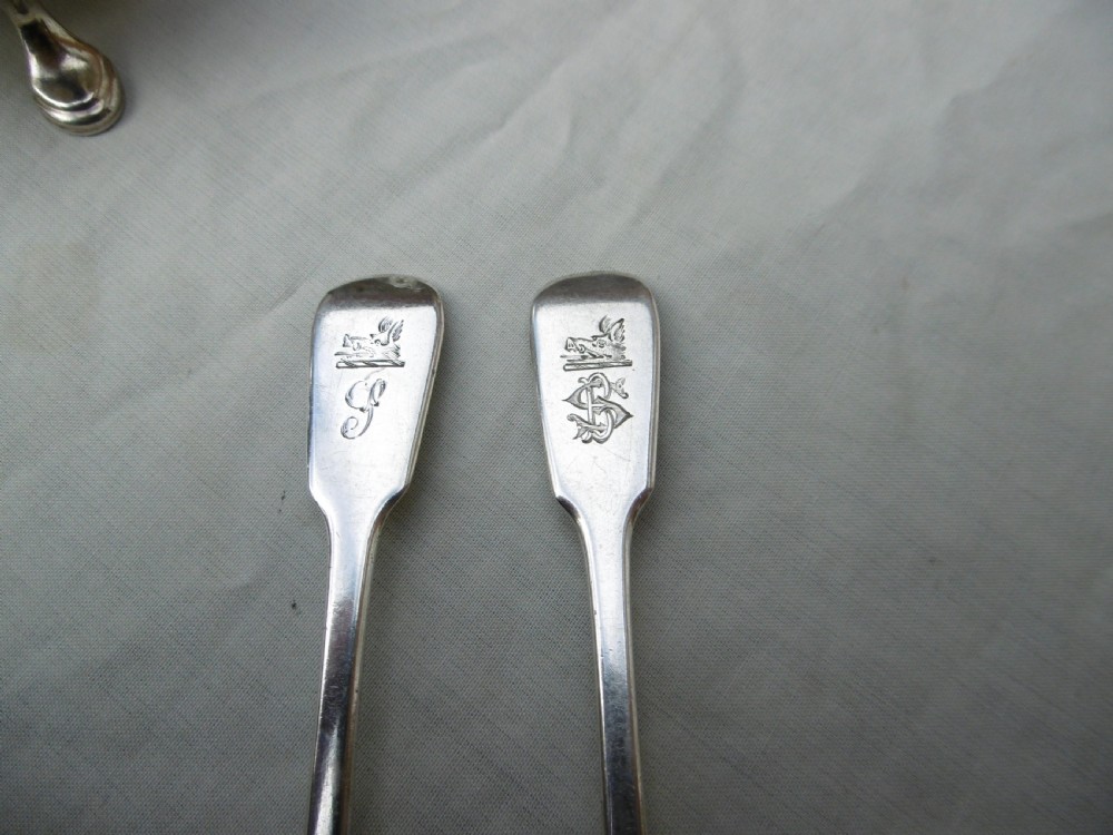 A pair of circular Scottish Georgian sterling silver open salt cellars with hoof feet alongside matching small silver salt spoons. View VII