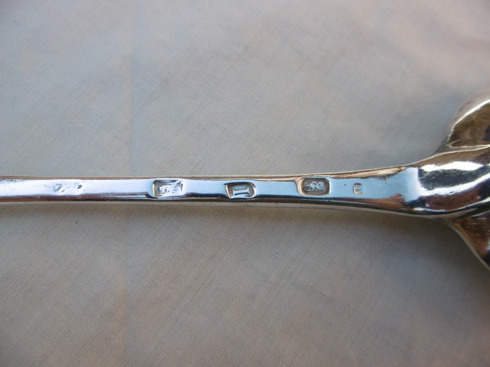A George I Britannia standard silver basting spoon featuring a long tapered handle and an oval bowl with a rat-tail joint. View II