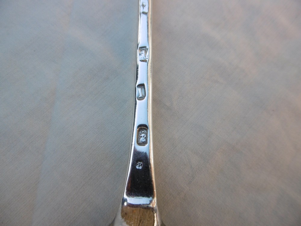 A George I Britannia standard silver basting spoon featuring a long tapered handle and an oval bowl with a rat-tail joint. View III