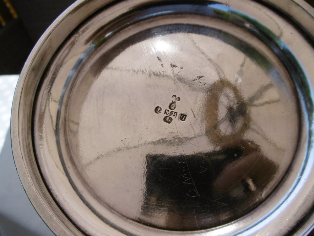 A Georgian silver coffee pot featuring fluted lower body detailing, an engraved crest, and a carved wooden handle. View II