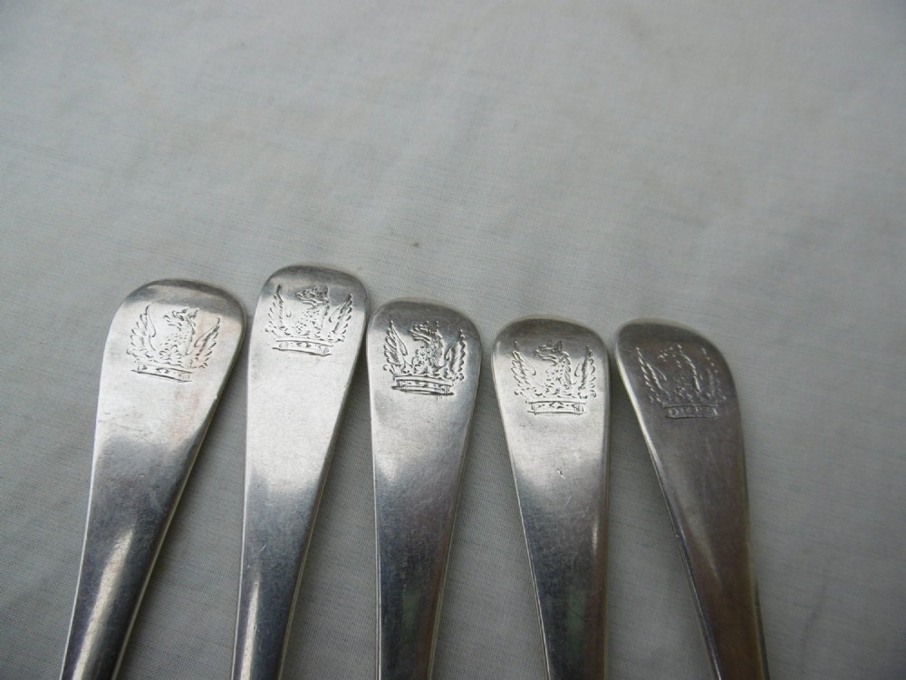 A set of five mid-eighteenth-century sterling silver dessert forks with three prongs and slender Hanoverian-style stems. View III