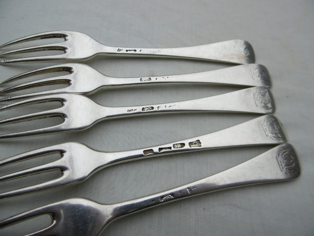 A set of five mid-eighteenth-century sterling silver dessert forks with three prongs and slender Hanoverian-style stems. View IV