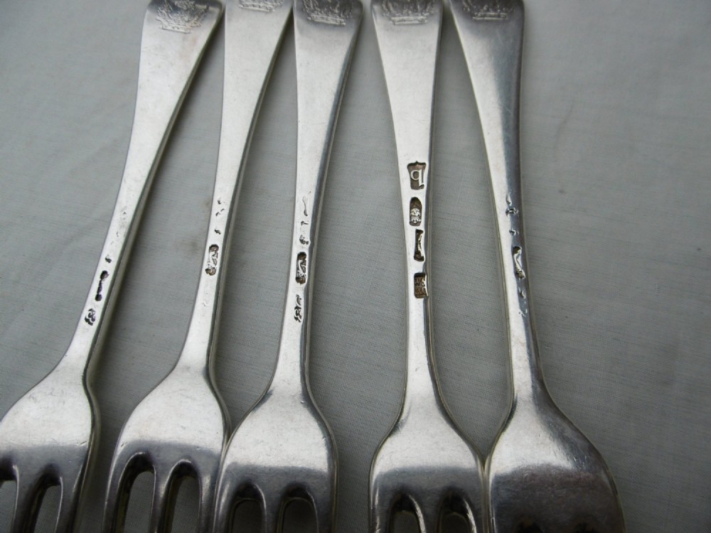 A set of five mid-eighteenth-century sterling silver dessert forks with three prongs and slender Hanoverian-style stems. View V