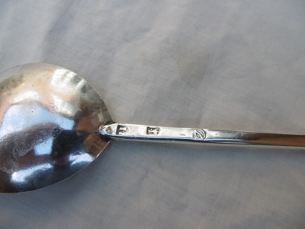 A sterling silver spoon featuring a wide fig-shaped bowl, a slim straight stem, and a rounded seal top terminal. View II