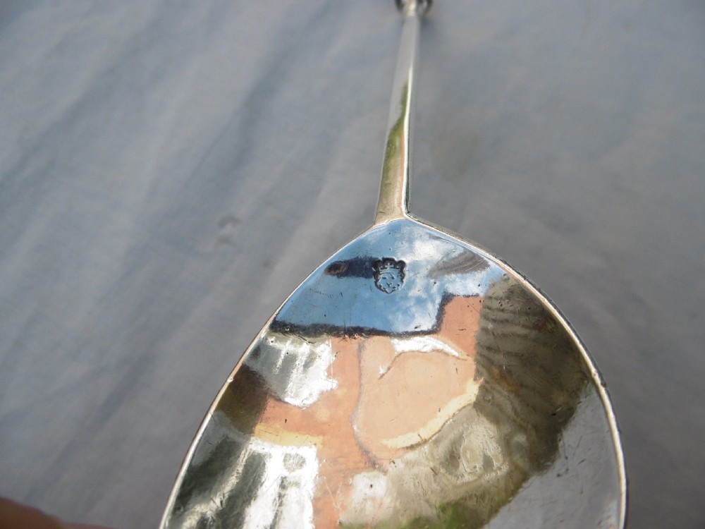 A sterling silver spoon featuring a wide fig-shaped bowl, a slim straight stem, and a rounded seal top terminal. View VI