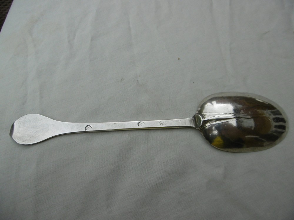 An antique silver dognose tablespoon featuring a rounded oval bowl with a rat-tail stem connection and hallmarks along the narrow handle.