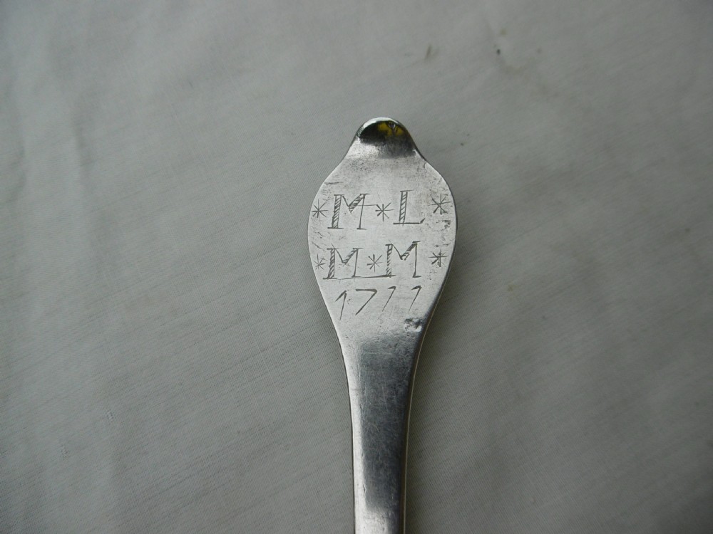 An antique silver dognose tablespoon featuring a rounded oval bowl with a rat-tail stem connection and hallmarks along the narrow handle. View V