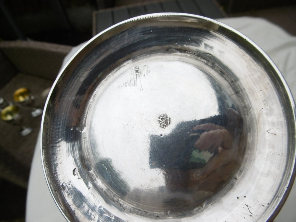 A George II sterling silver coffee pot with a tapered body, domed lid, decorative cast spout, and a curved wooden handle. View IV