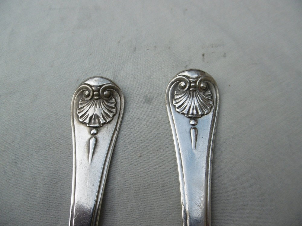 A mid-eighteenth-century sterling silver spoon and four-tined fork crafted in the Hanoverian Thread, Shell and Drop pattern. View V