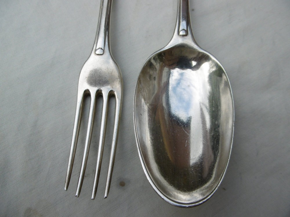 A mid-eighteenth-century sterling silver spoon and four-tined fork crafted in the Hanoverian Thread, Shell and Drop pattern. View VI