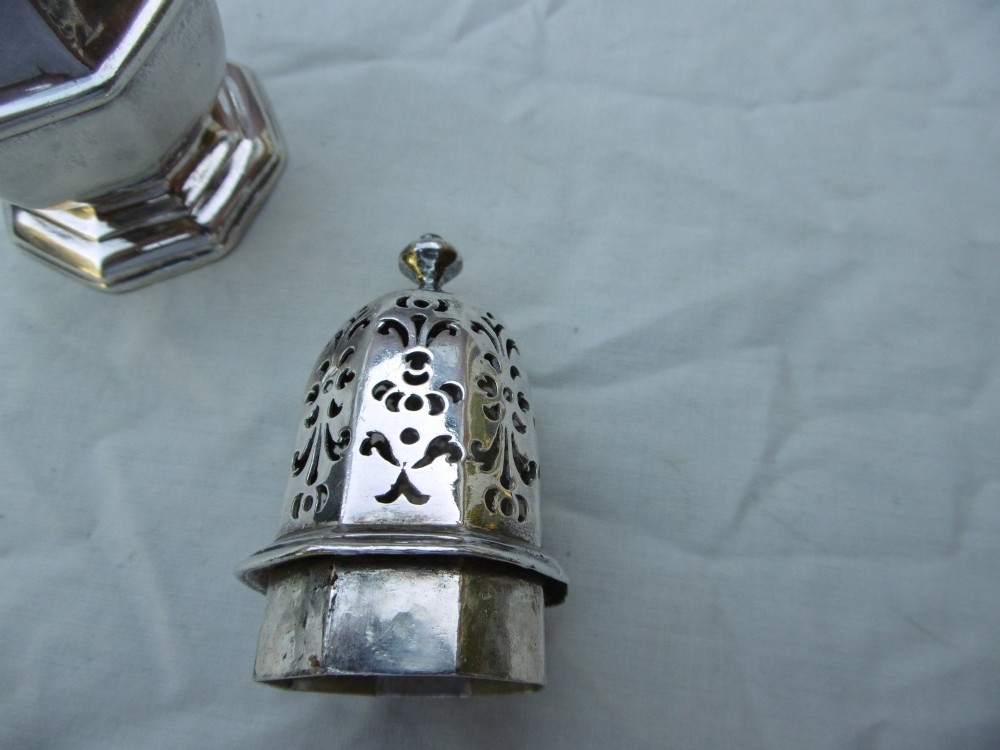 An 18th-century octagonal sterling silver sugar caster featuring a baluster-shaped body, moulded foot, and intricate pierced dome lid topped with a finial. View IV