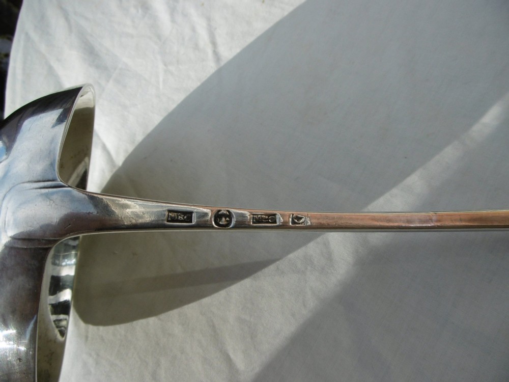 An eighteenth-century Georgian solid silver soup ladle featuring a deep round bowl and a gently curved handle stem. View II