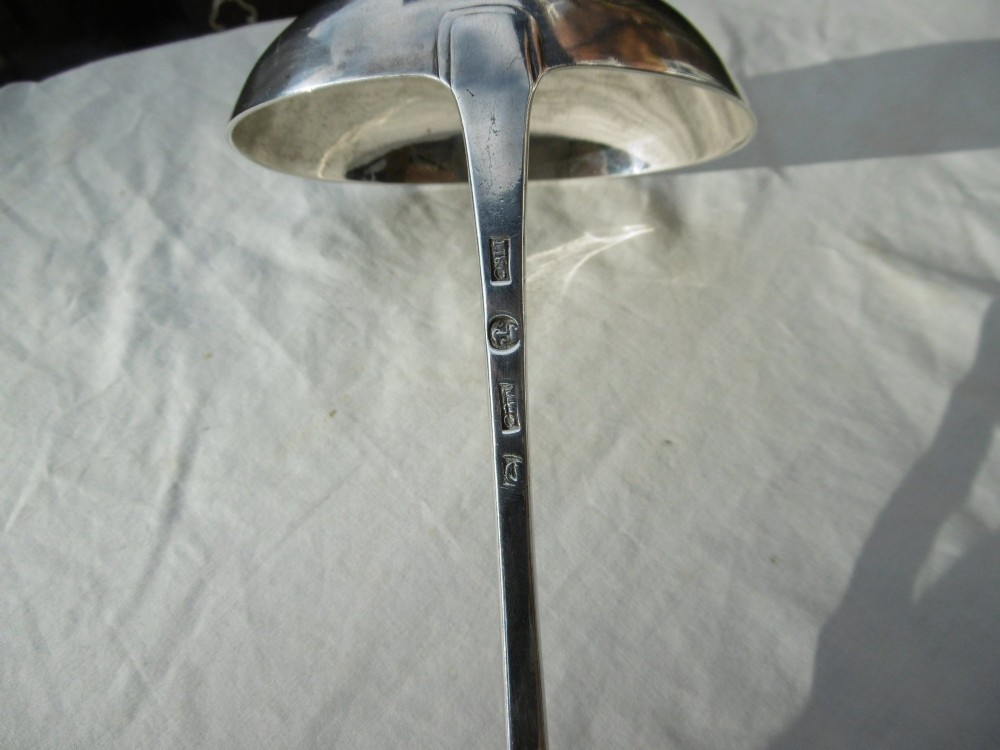 An eighteenth-century Georgian solid silver soup ladle featuring a deep round bowl and a gently curved handle stem. View III