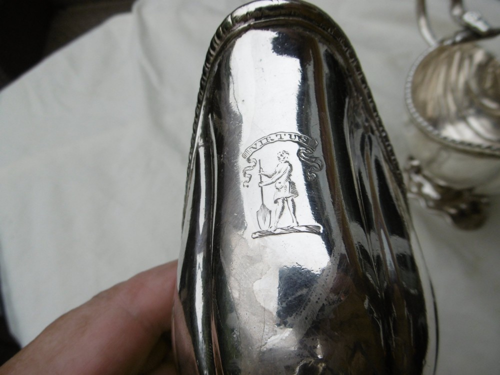 A pair of 18th-century Georgian sterling silver sauce boats featuring fluted shell bodies, serpent handles, and pedestal bases. View III