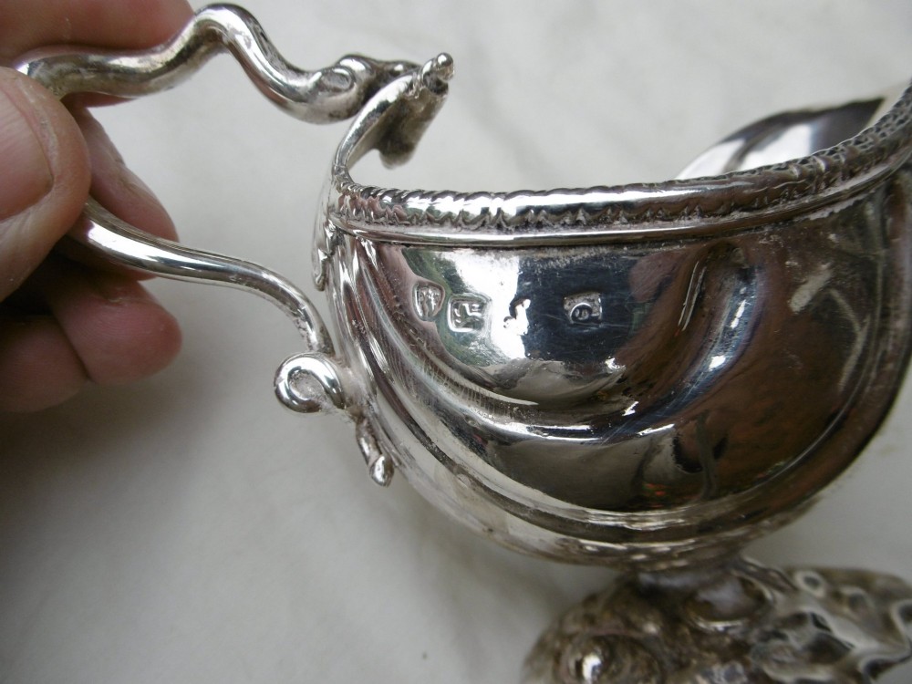 A pair of 18th-century Georgian sterling silver sauce boats featuring fluted shell bodies, serpent handles, and pedestal bases. View VI