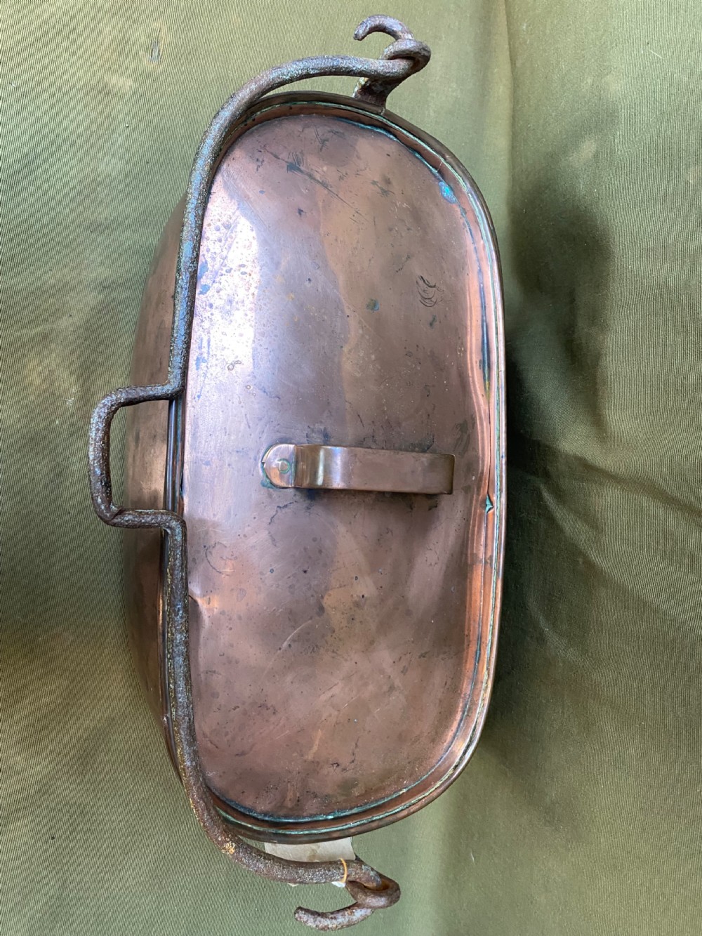 An oval antique copper fish kettle with a fitted copper lid and heavy wrought iron handles on either side. View II