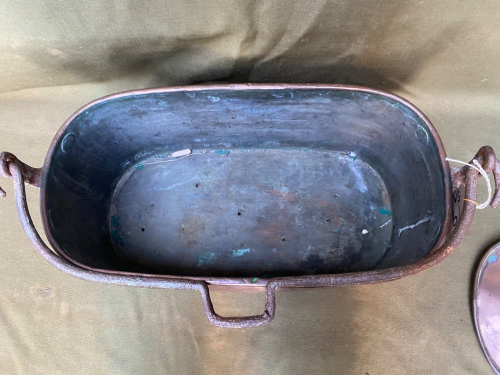An oval antique copper fish kettle with a fitted copper lid and heavy wrought iron handles on either side. View III