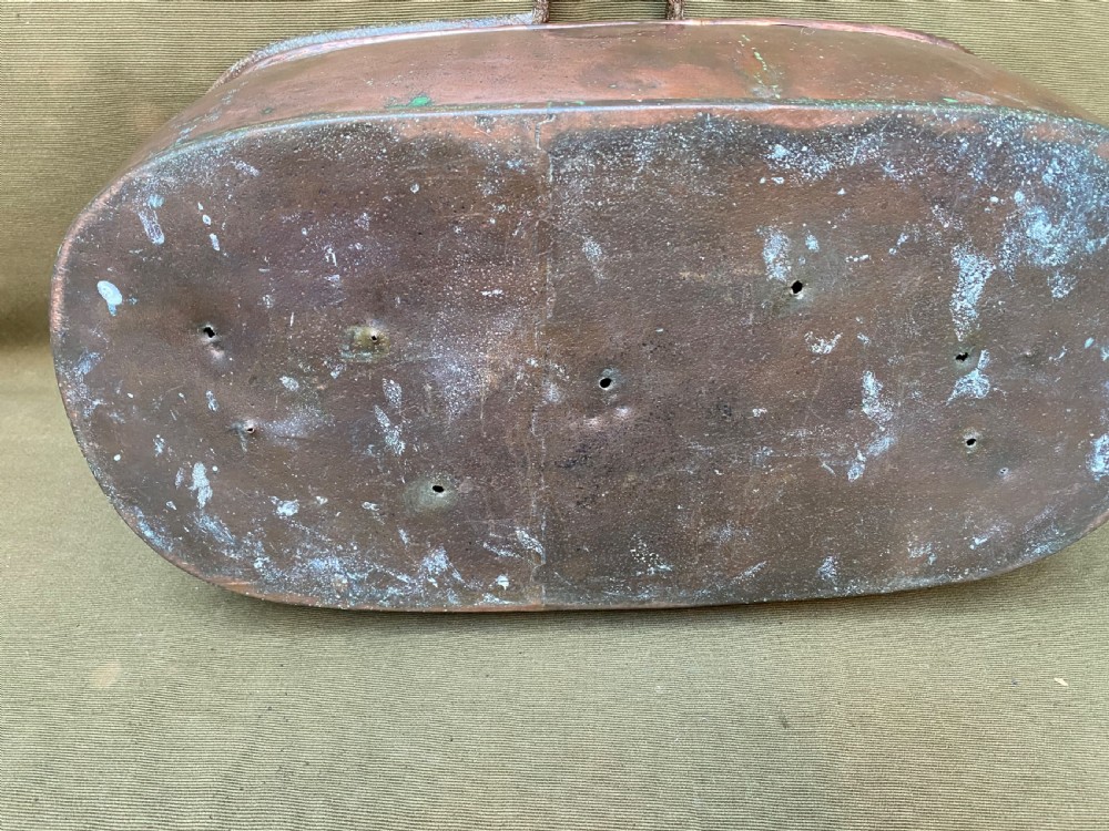 An oval antique copper fish kettle with a fitted copper lid and heavy wrought iron handles on either side. View IV