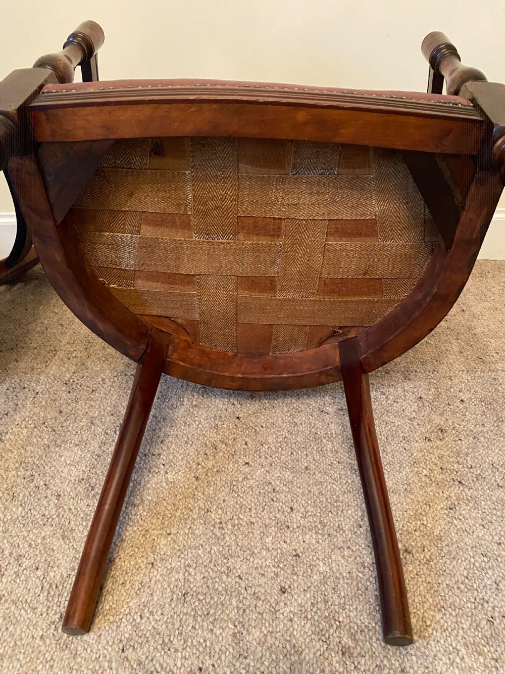 A pair of mahogany club armchairs featuring vertical slat backrests, curved arms with turned supports, and reddish-brown leather upholstered seats with stud detailing. View VIII