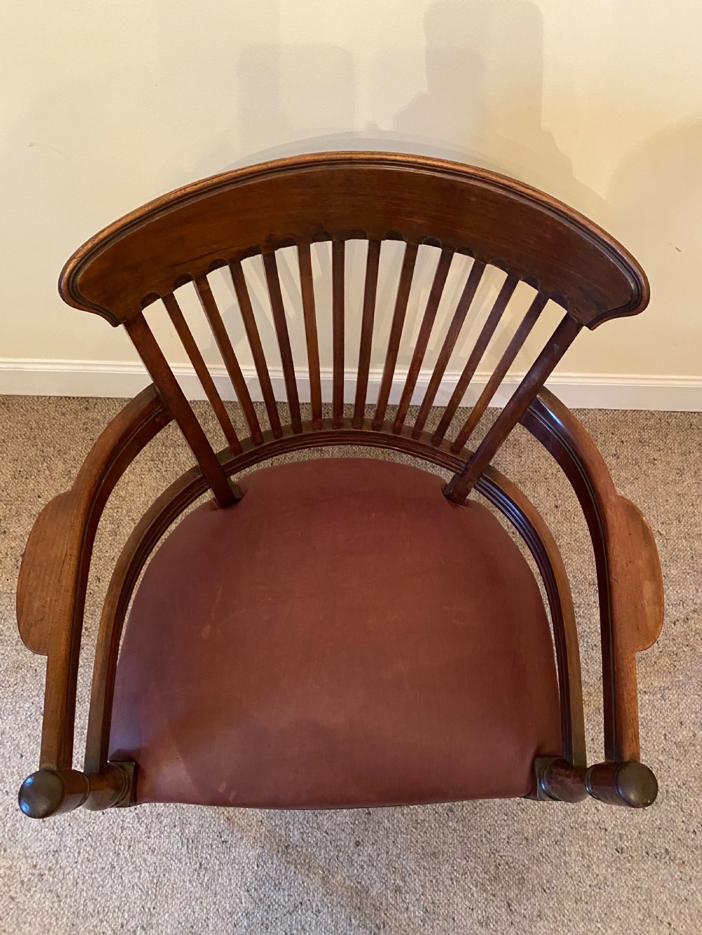 A pair of mahogany club armchairs featuring vertical slat backrests, curved arms with turned supports, and reddish-brown leather upholstered seats with stud detailing. View XI