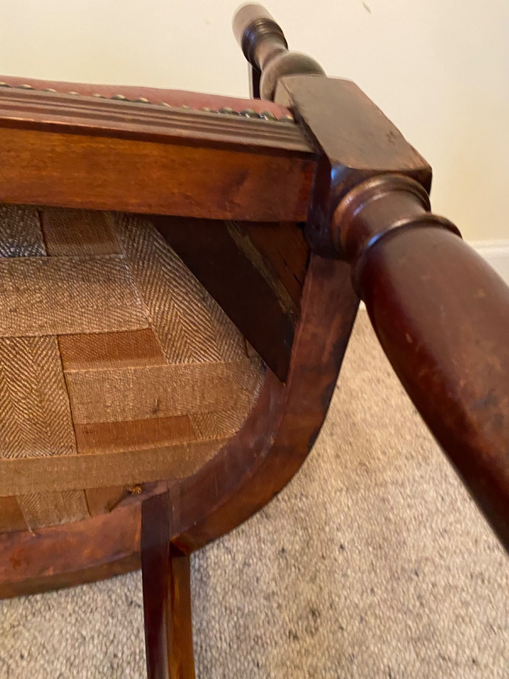 A pair of mahogany club armchairs featuring vertical slat backrests, curved arms with turned supports, and reddish-brown leather upholstered seats with stud detailing. View XVI