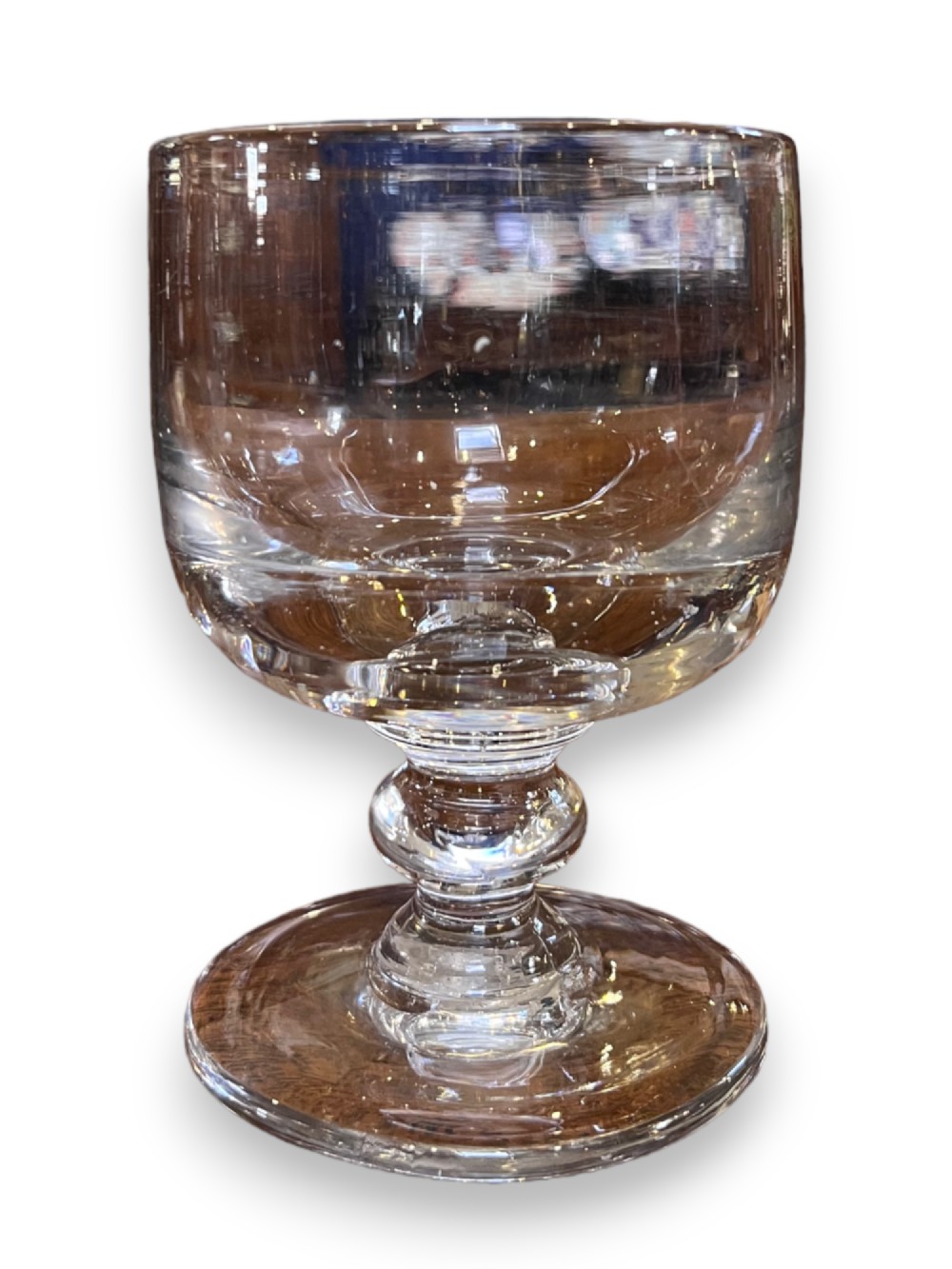 A clear Georgian glass rummer featuring a wide cylindrical bowl, a short stem with a central rounded knop, and a flat circular foot.