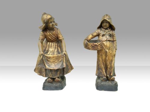 A Fabulous Pair of Antique Goldscheider Figures of Boy and Girl in Dutch Dress