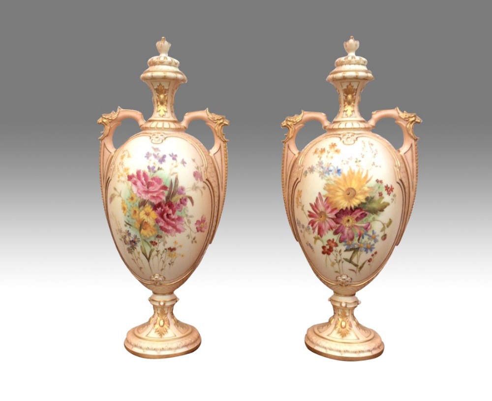 A stunning pair of large Antique Royal Worcester blush ivory twin handled vases and covers.