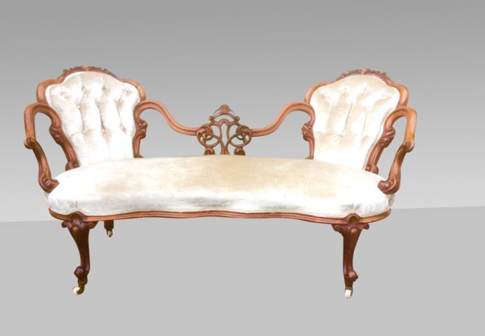 A beautiful antique walnut window seat settee of small proportions .