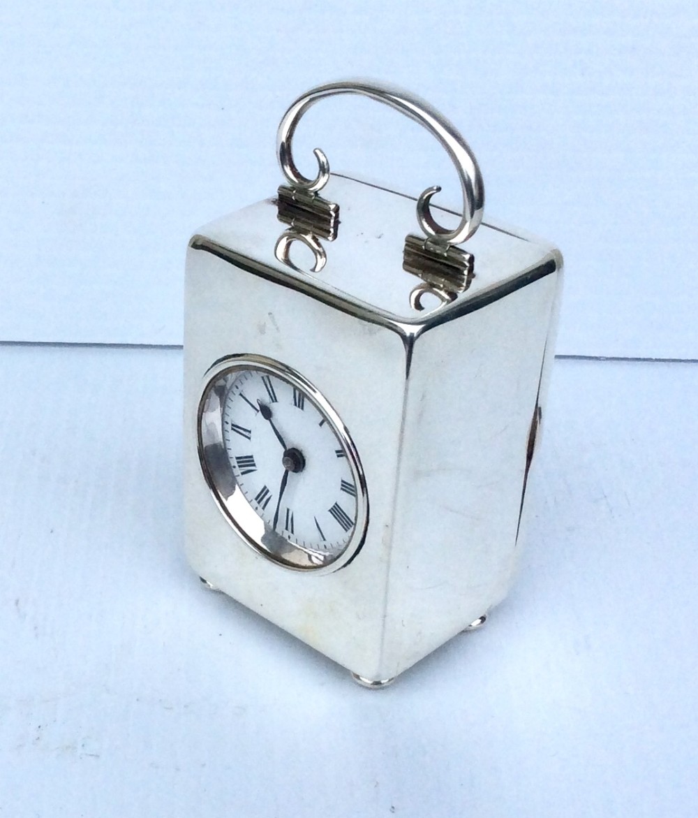 A beautiful small antique sterling silver timepiece boudoir carriage clock.French Movement, 