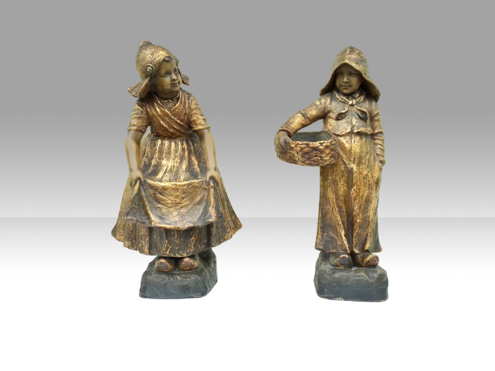 A Fabulous pair of antique Goldscheider figures Of boy and girl in Dutch dress