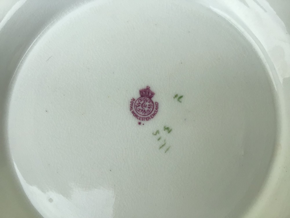 An antique Royal Worcester blush ivory loving cup featuring two ornate gilt scroll handles and hand-painted floral decoration on a peach-tinted ground. View VIII