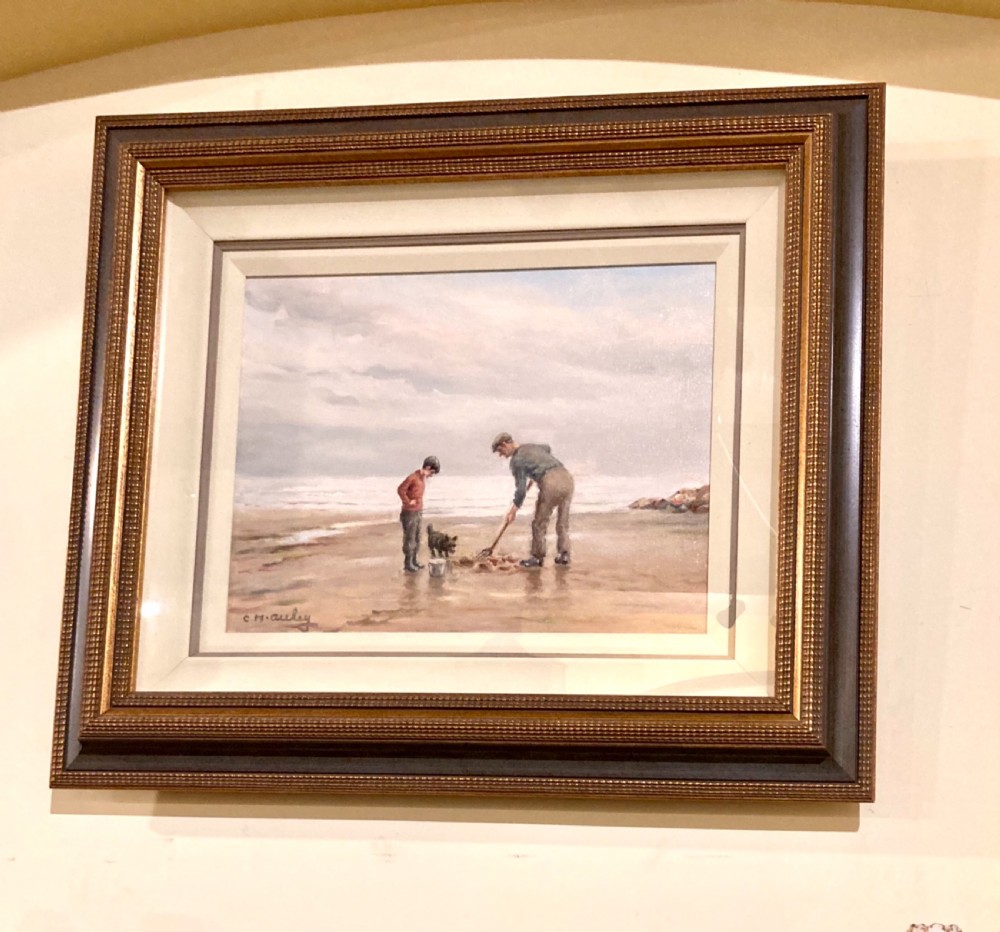An oil painting on canvas depicting figures and a dog on a sandy shoreline, presented in a stepped gilded and textured wooden frame. View III