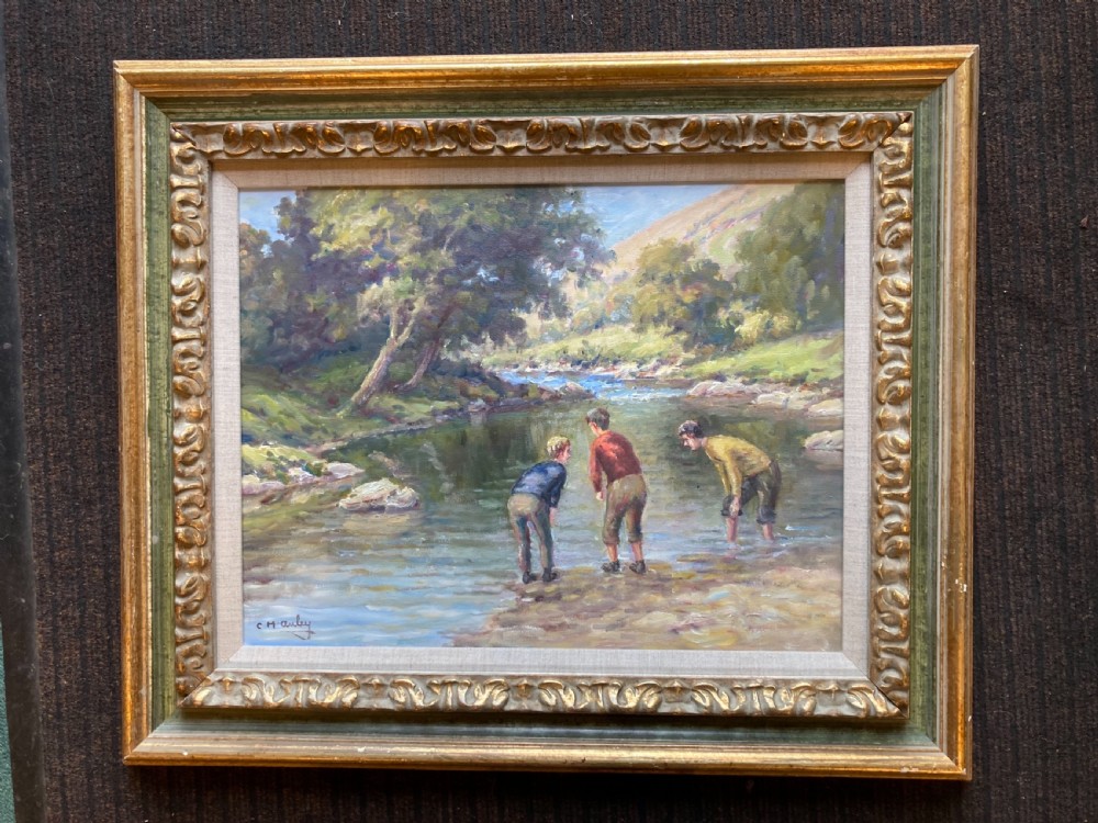 An original oil painting on canvas depicting three figures in a river landscape, framed in a carved gilt and green moulding with a textured slip.