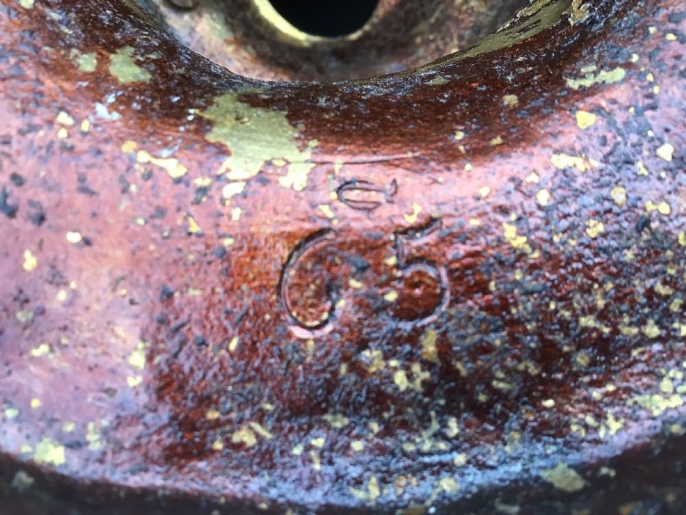 A large gilt and patinated bronze Warwick vase featuring classical relief faces around the central bowl and interwoven vine handles. View VI