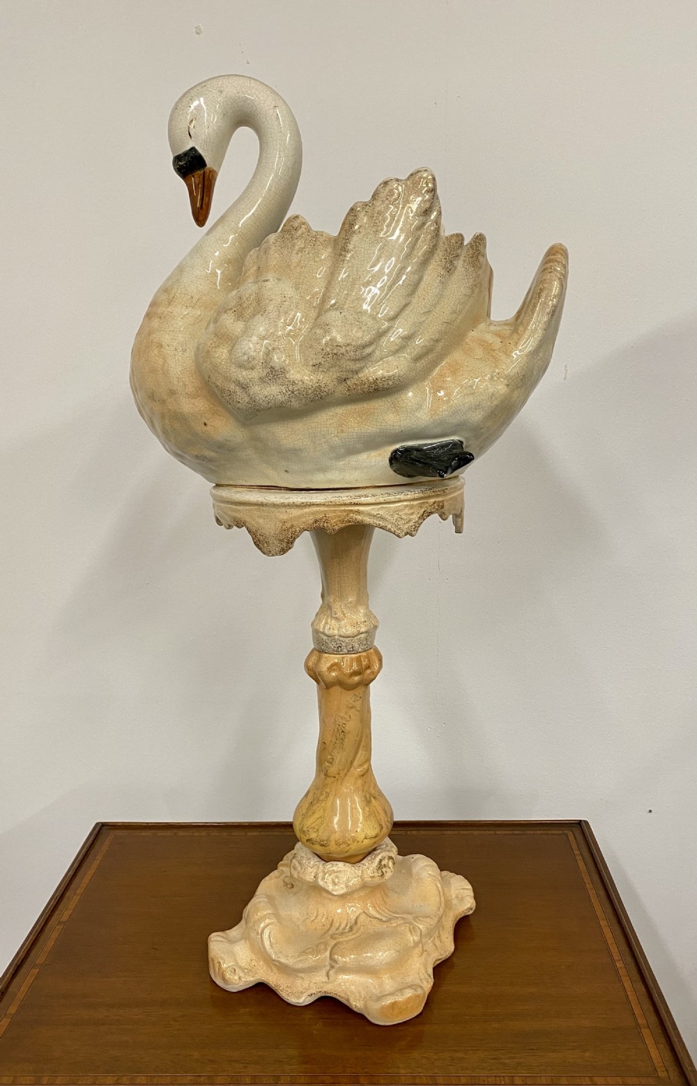 A cream glazed ceramic Victorian jardiniere formed in the shape of a swan resting atop a tall matching ornate pedestal base. View III