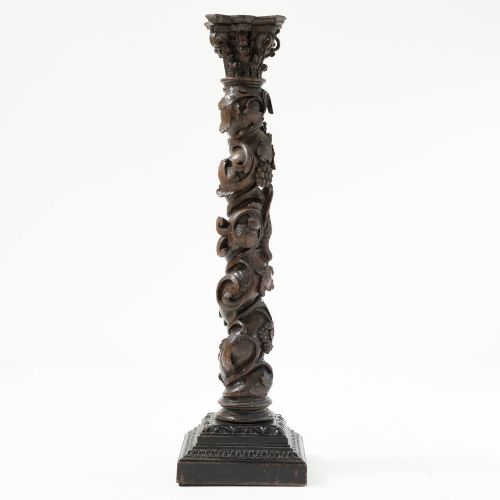 fig 1. A dark carved oak Solomonic pedestal column with a spiralled grapevine shaft, Corinthian capital, and stepped square base.