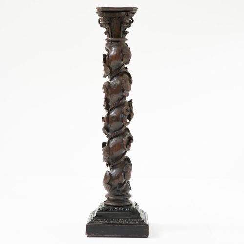 fig 2. A dark carved oak Solomonic pedestal column with a spiralled grapevine shaft, Corinthian capital, and stepped square base.