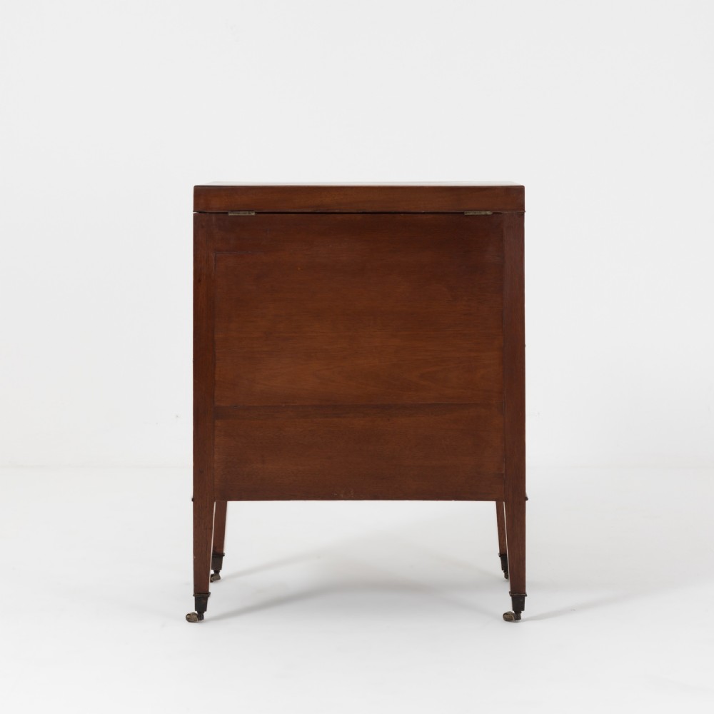 A George III mahogany travelling dressing chest featuring multiple drawer arrangements with circular brass handles, raised on square tapered legs with castors. View IV