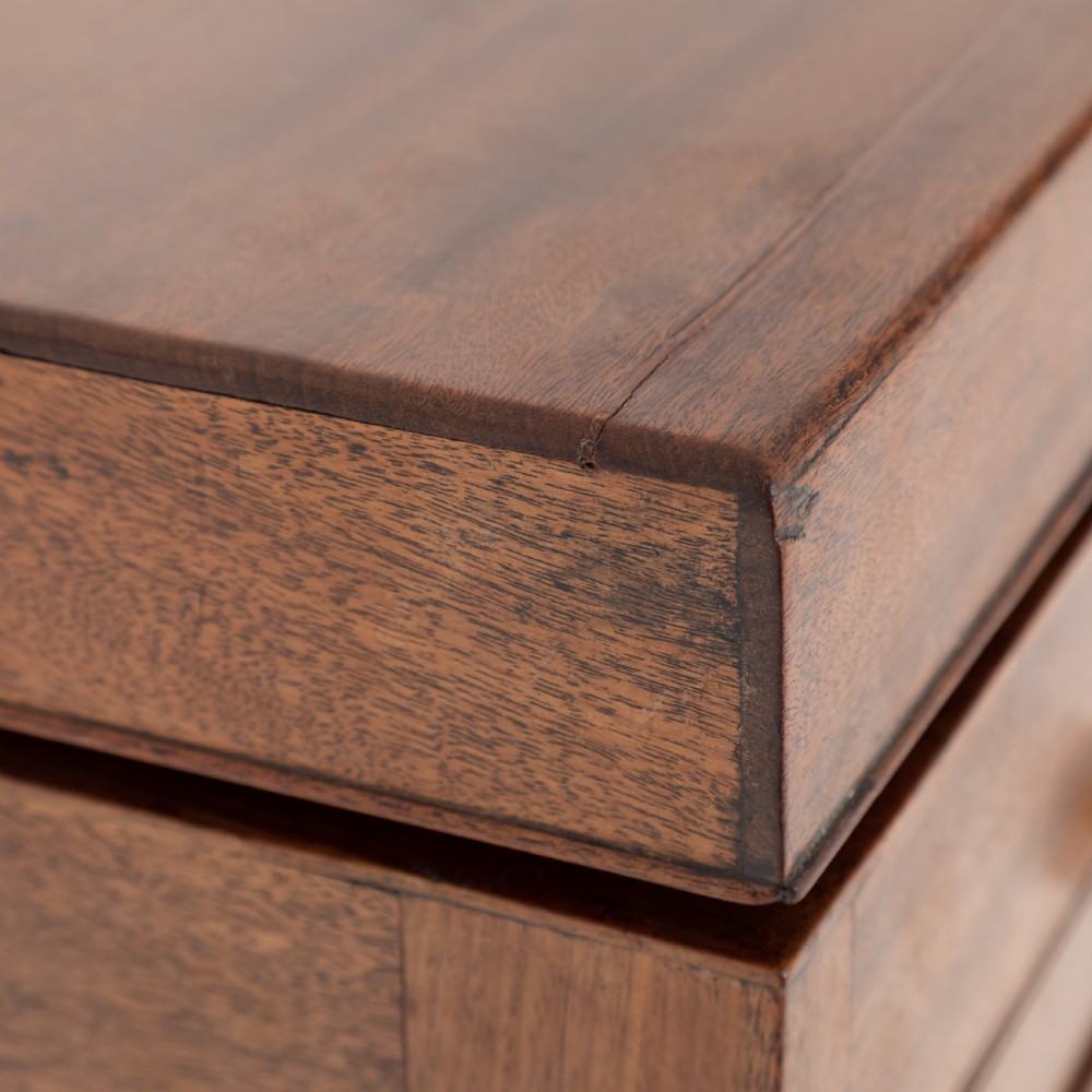 A George III mahogany travelling dressing chest featuring multiple drawer arrangements with circular brass handles, raised on square tapered legs with castors. View XVII