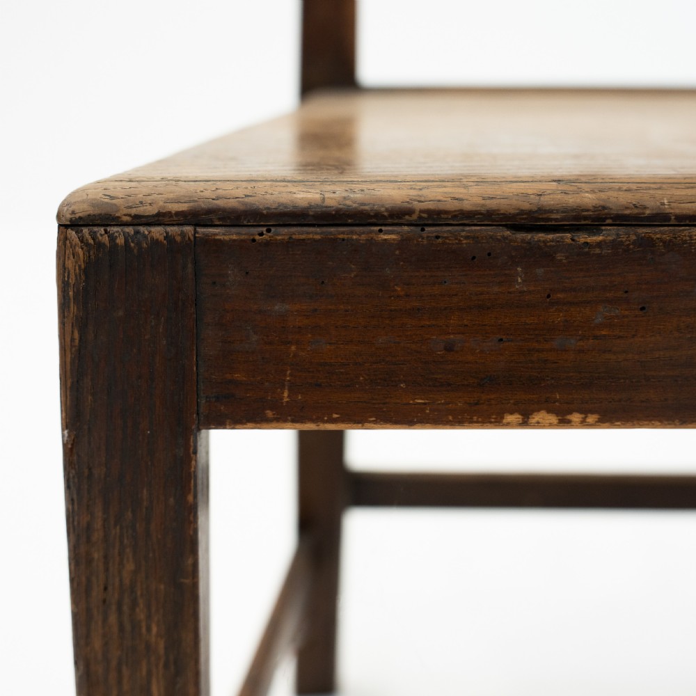 A set of three 18th-century dark wooden farmhouse chairs featuring vertical slat backs, solid wooden seats, and straight legs connected by stretchers. View VIII