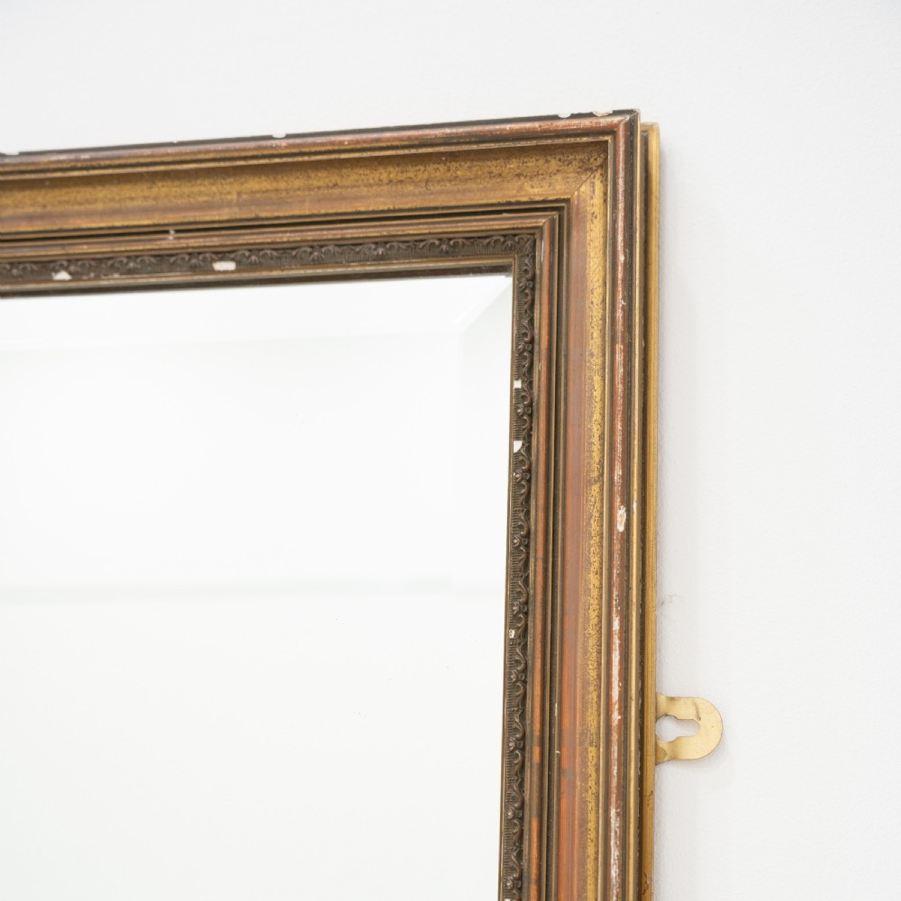 A tall rectangular wall mirror featuring a narrow giltwood frame with subtle moulded edge detailing. View II