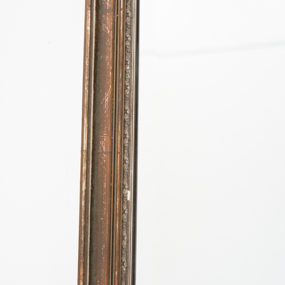 A tall rectangular wall mirror featuring a narrow giltwood frame with subtle moulded edge detailing. View III