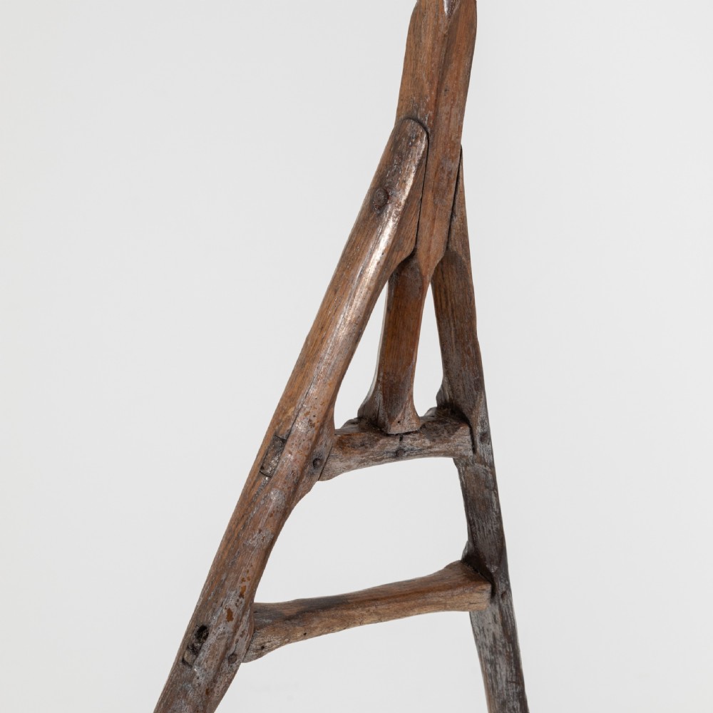 A late nineteenth-century ash hay rake featuring an elongated split-shaft handle and a wide timber head with curved tines. View VII