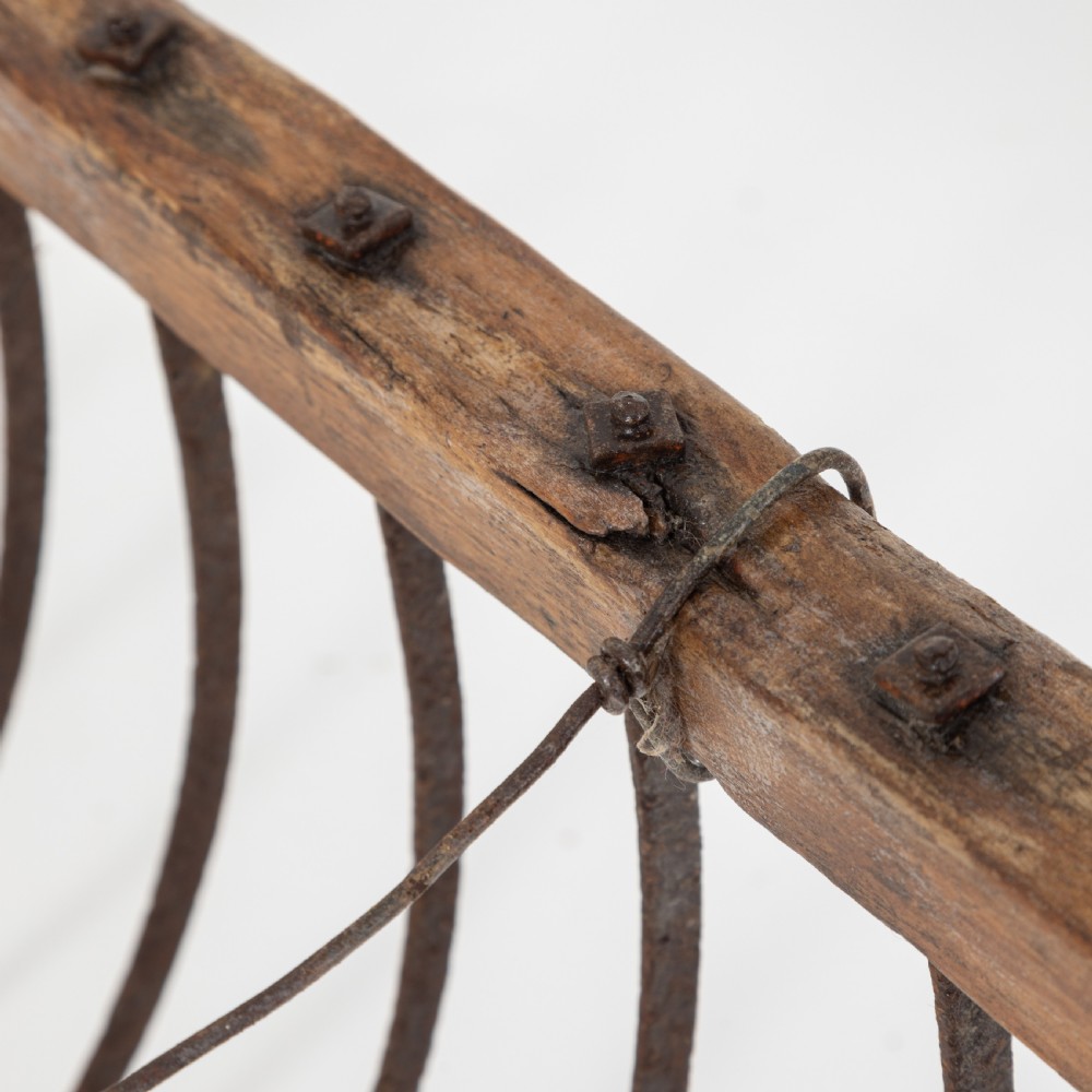 A late nineteenth-century ash hay rake featuring an elongated split-shaft handle and a wide timber head with curved tines. View XI